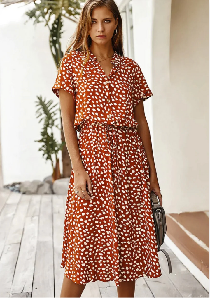 Effortless spotted button-down midi dress with delicate flutter sleeves.