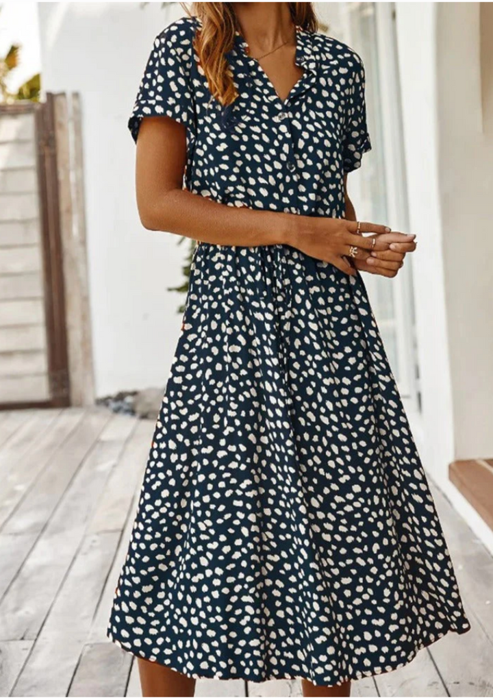 Stylish women's spotted midi dress, perfect for spring or summer casual wear.