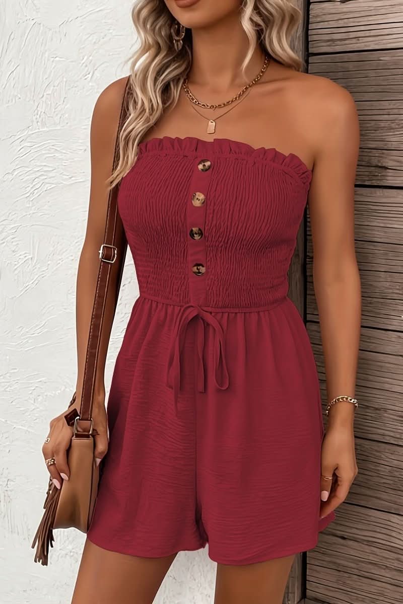Trendy women's summer playsuit. Strapless, button-front design in vibrant apricot.