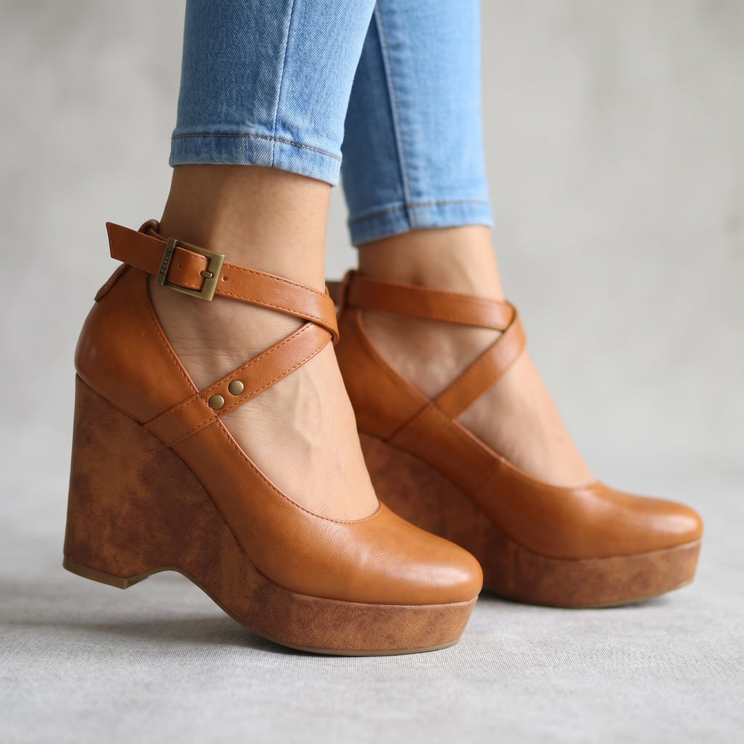 Chic women's platform wedge sandals with elegant cross-front straps, perfect for versatile summer outfits.
