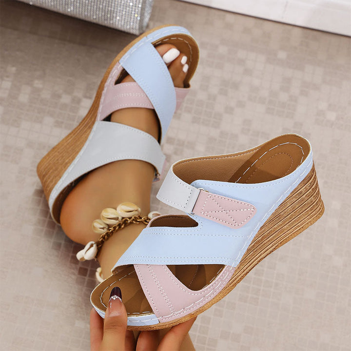 Women's open-toe strappy wedge platform sandals offering comfort for walking. Adjustable summer footwear.