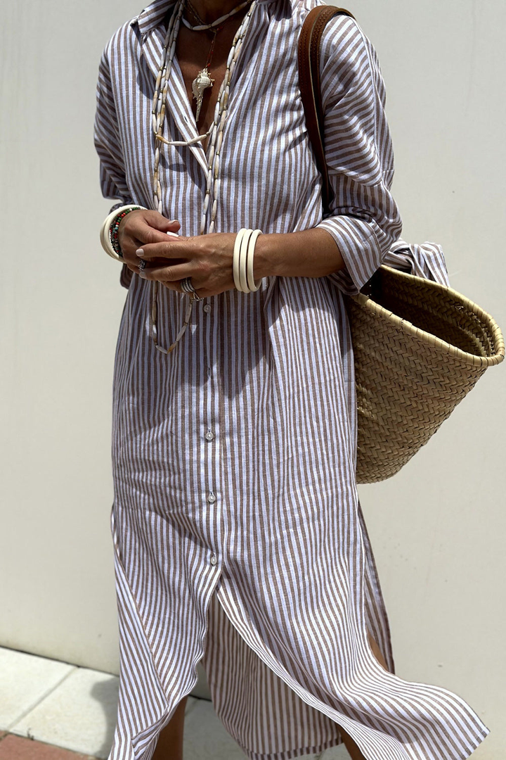 Close-up of collar and button-down detail on a women's striped oversized midi dress. Casual spring look.