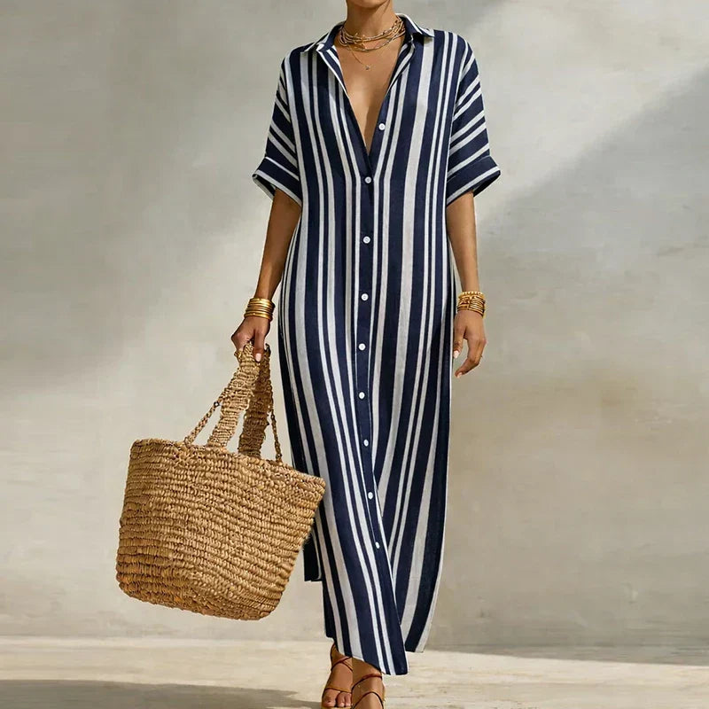 Flowy women's striped shirt dress with v-neck and three-quarter sleeves. Ideal for warm weather and casual wear.