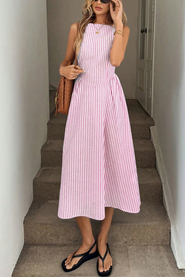 Vibrant striped pleated midi dress for women, with a fashionable halter neck, perfect for sunny summer days.