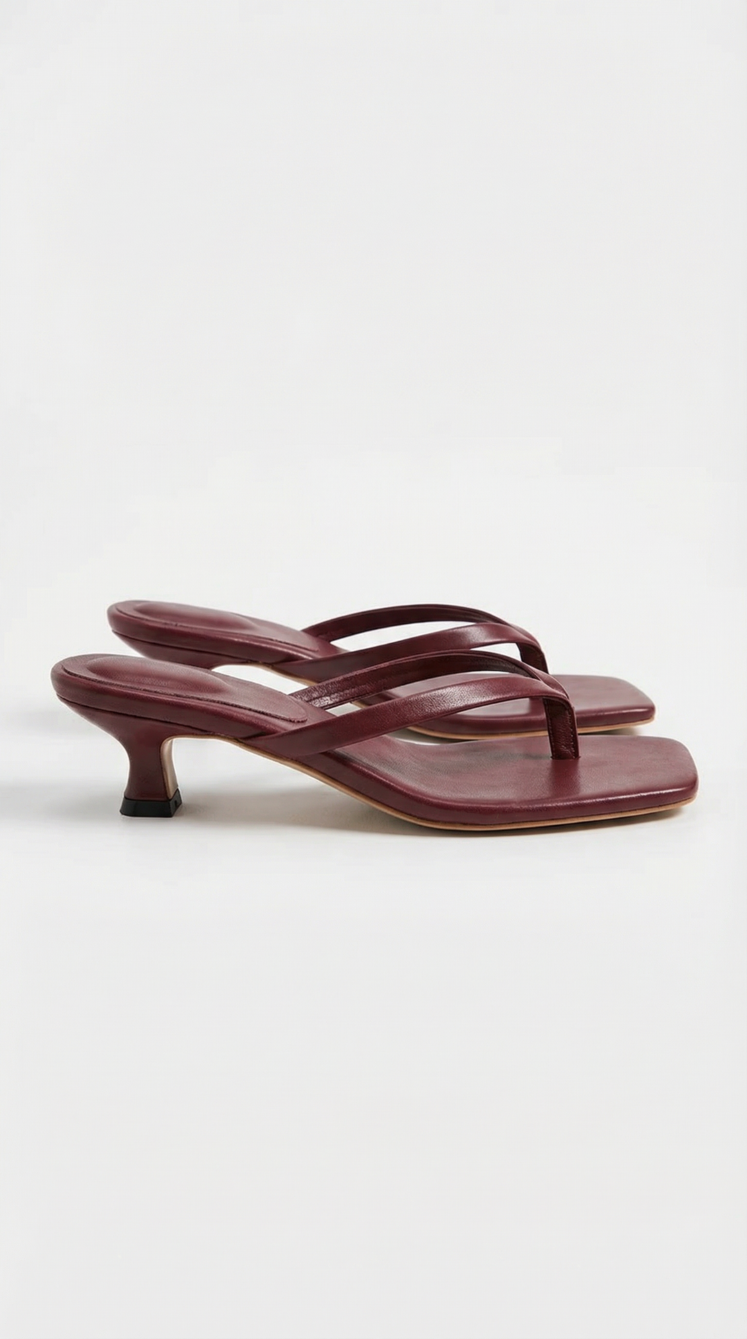 Dressy women's slip-on sandals with a subtle kitten heel and thong strap.