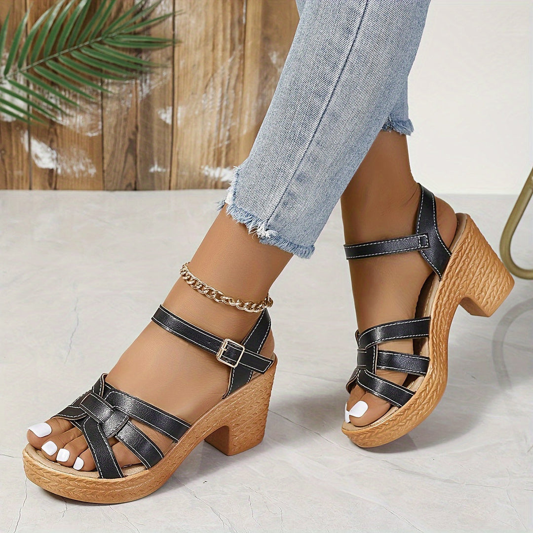 Women's stylish black wedge sandals with ankle strap, perfect for summer comfort.