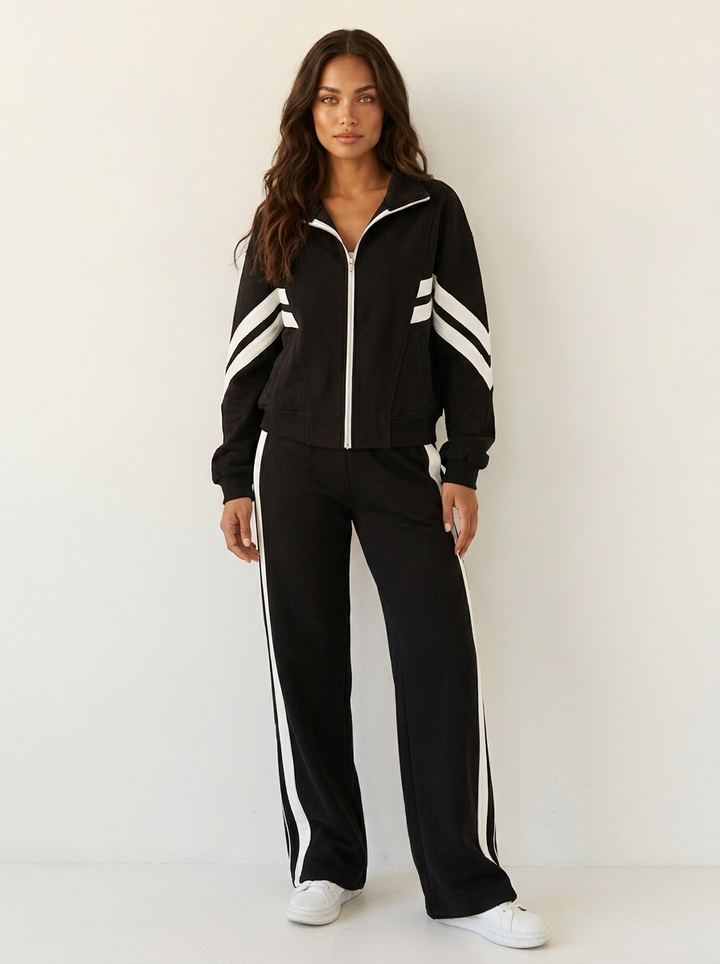 Sporty chic women's matching tracksuit set, zip-up top, wide-leg bottoms, fashionable contrast stripes.