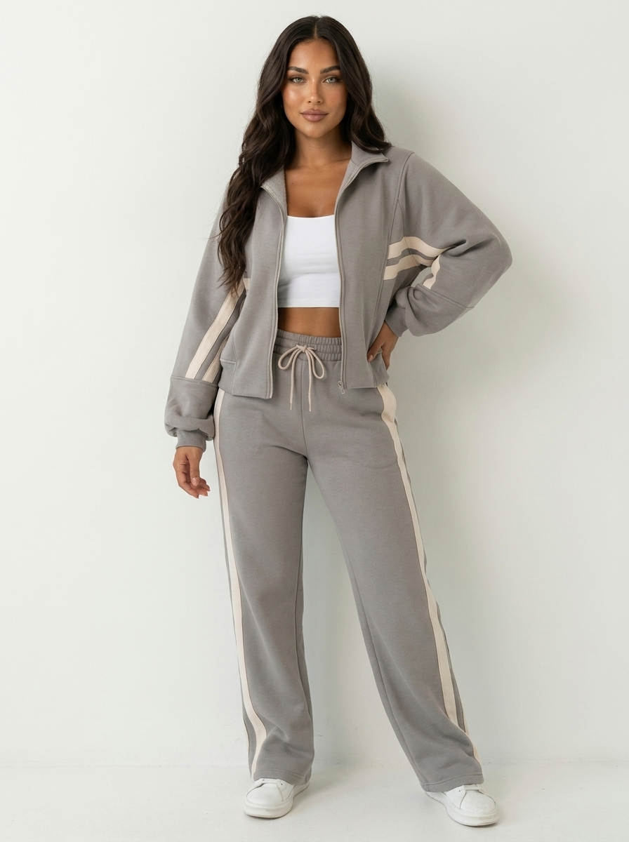 Stylish women's zip-up tracksuit set with contrast stripes & wide-leg pants. Comfortable matching loungewear.