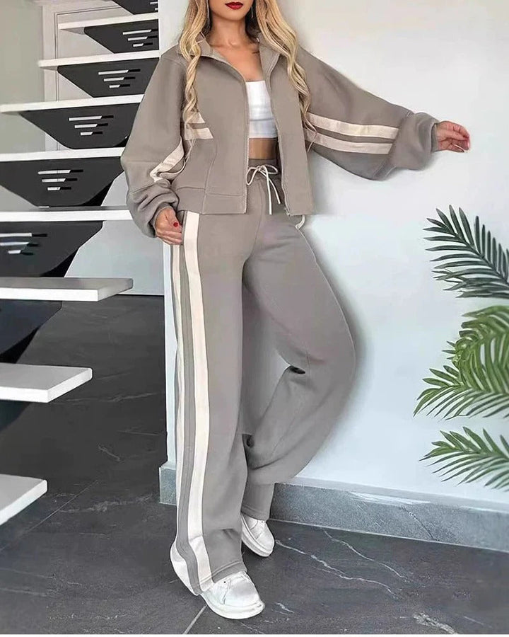 Fashionable women's matching tracksuit, zip-up jacket, wide-leg pants, contrast stripe design, comfortable.
