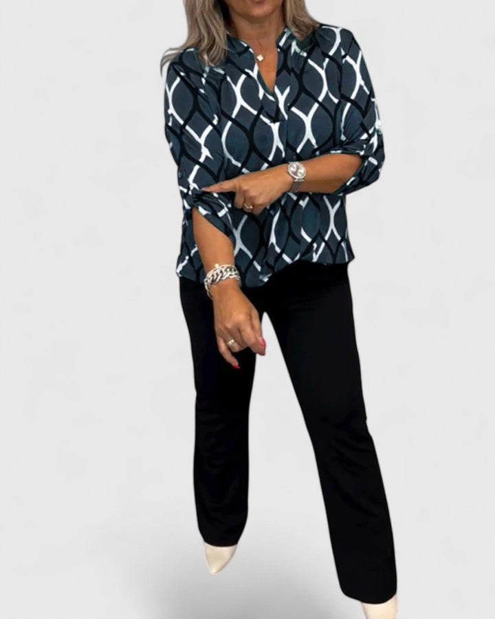 Comfortable women's top featuring a modern graphic print and chic three-quarter sleeves.