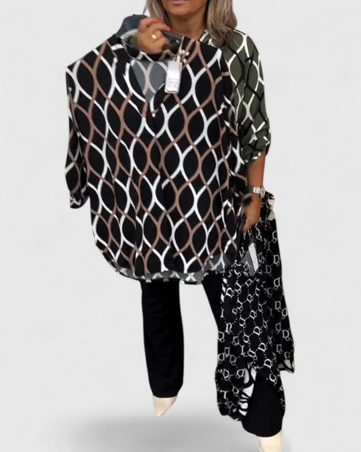 Versatile women's blouse with a vibrant graphic print and three-quarter sleeves for casual or office wear.