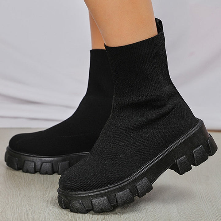 Side view of women's stylish slip-on ankle boots, offering comfort and versatile fashion footwear.