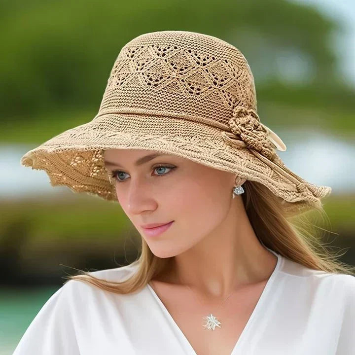 Elegant Dorothea women's sun hat with a wide brim and intricate lace detail, a chic summer accessory.