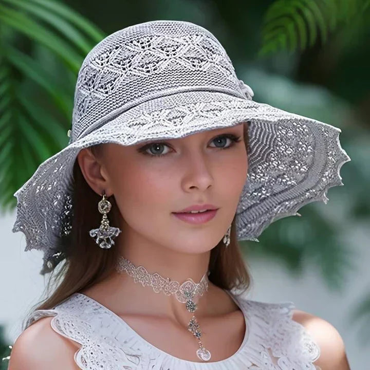 Dorothea women's wide brim sun hat, foldable and adjustable, with an elegant lace pattern detail.