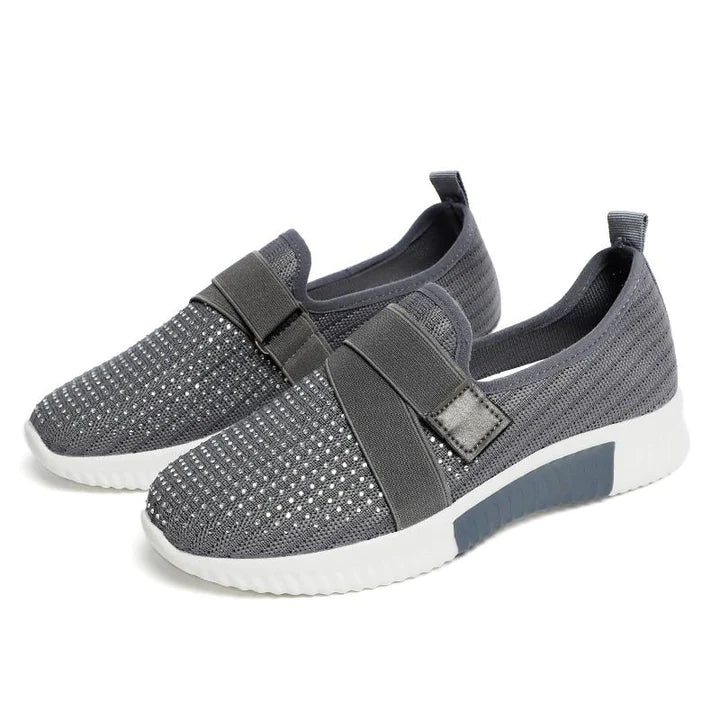 Adjustable fit women's slip-on sneakers, providing supportive comfort for an active lifestyle & everyday wear.