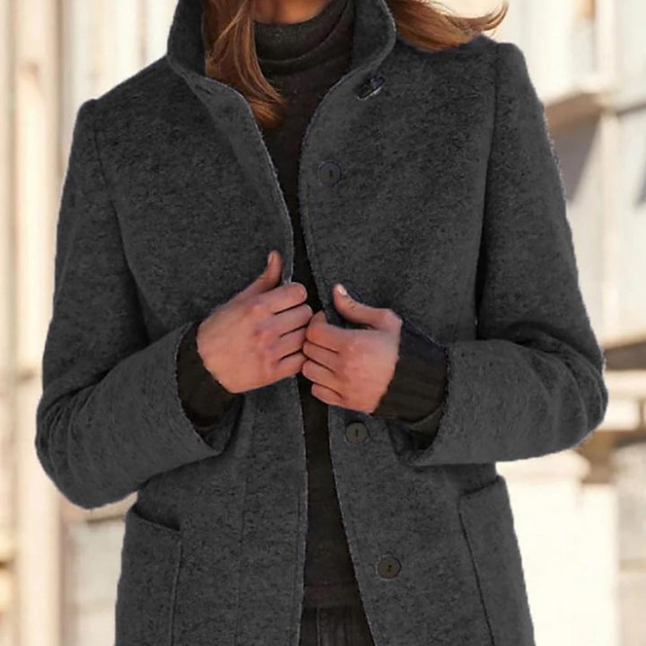 Sophisticated women's mid-length tailored coat, elegant button closure. Elevate your workwear or casual style.