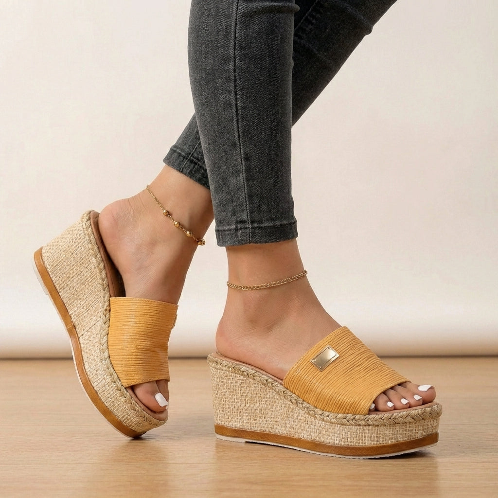 Stylish women's espadrille sandals featuring a unique textured strap and comfortable wedge platform for summer.