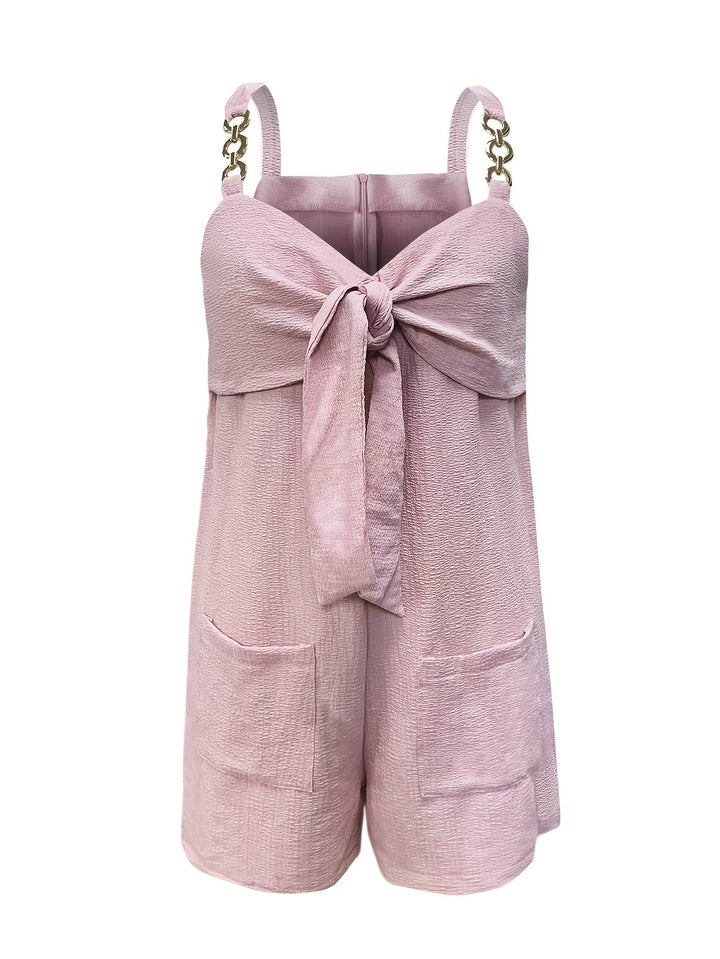 Flat lay of a women's textured romper with chain straps, highlighting its design for summer fashion.