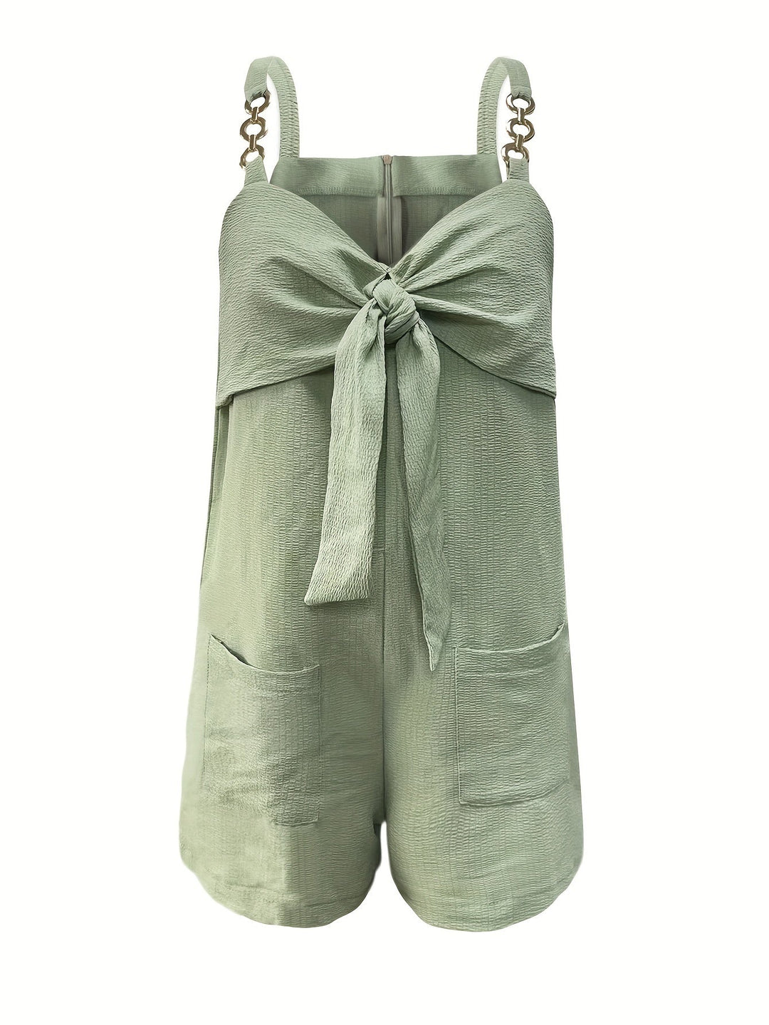 Woman walking, showcasing the flow of the textured romper with chain straps for active summer fashion.