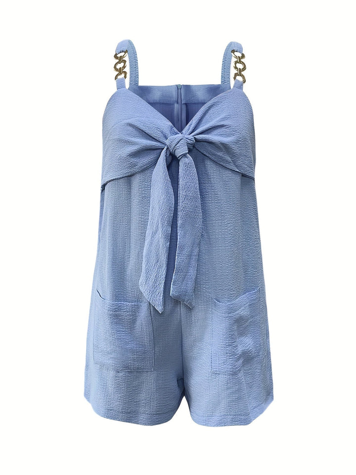 Women's textured sweetheart romper with chain straps styled with accessories for a complete party outfit.
