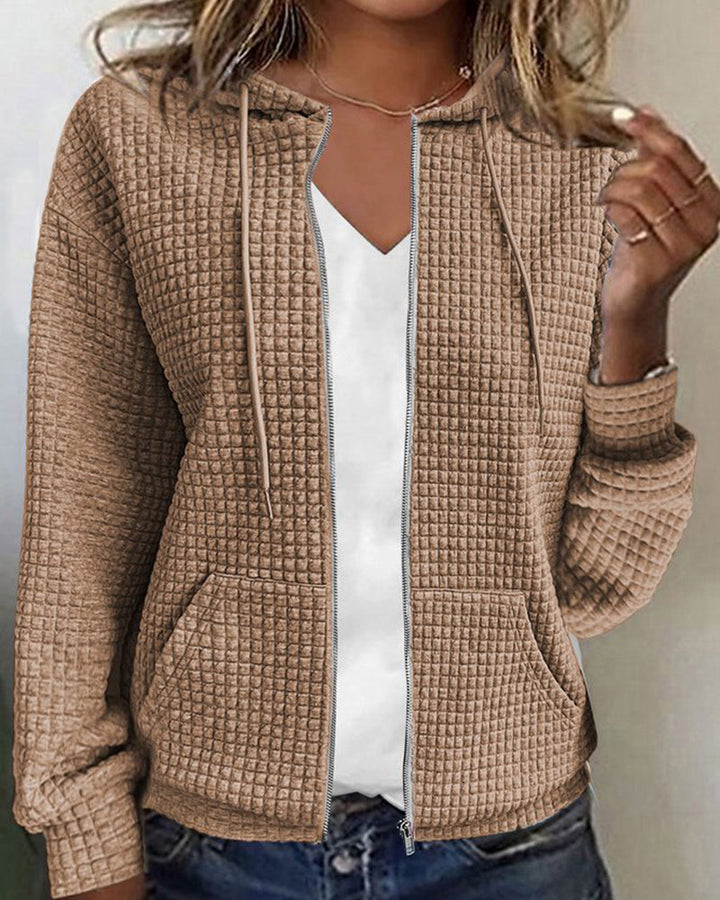 Pink women's textured zip-up hoodie jacket. Versatile hooded top with front pockets for casual everyday wear.
