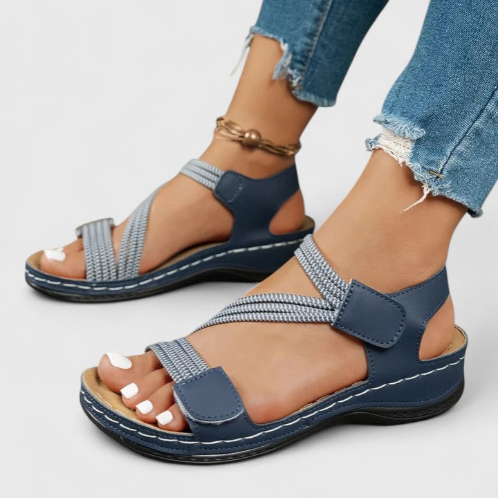 Woman enjoys comfortable walk in three-arch support orthopedic sandals, relieving foot pain.