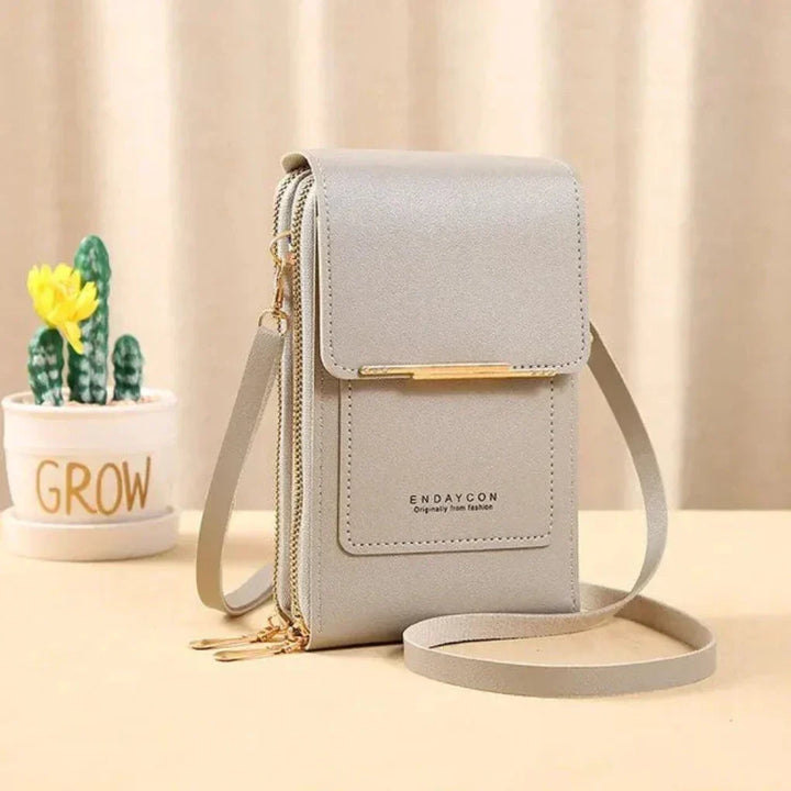 Organized women's phone bag: touch screen compatible, crossbody design, with strap for hands-free convenience & security.