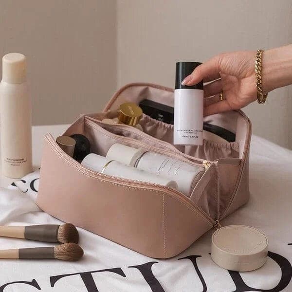 Women's travel cosmetic bag with multiple compartments, perfect for organized makeup and toiletry storage.