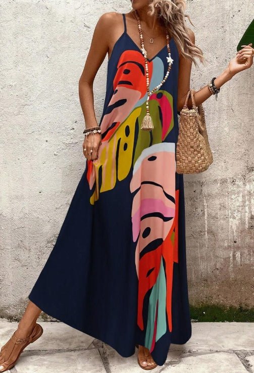 Sleeveless Women's Vacation Maxi Dress with a beautiful tropical leaf print. Long, elegant summer beachwear.