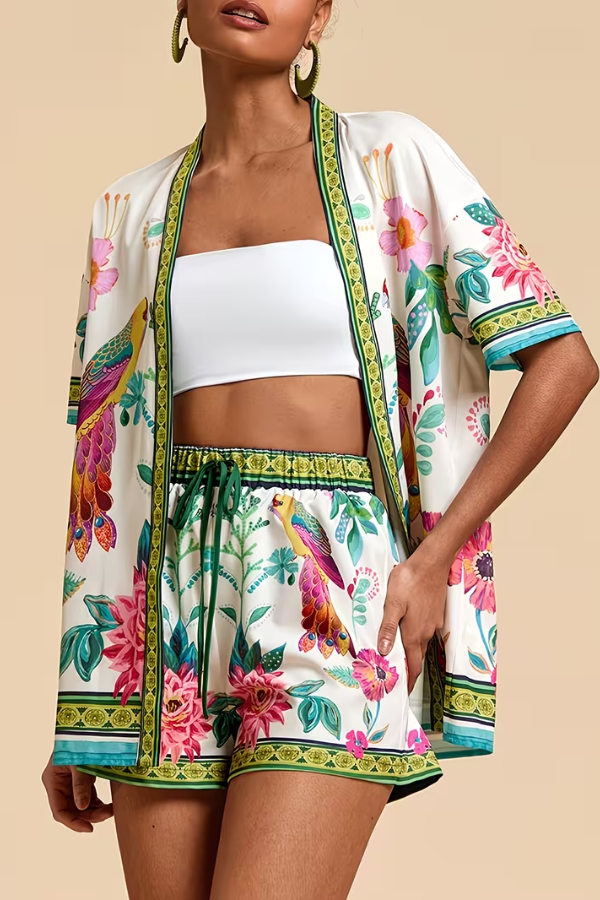 Casual women's two-piece summer set with vibrant tropical floral print. Short sleeve top & comfy shorts for resort wear.