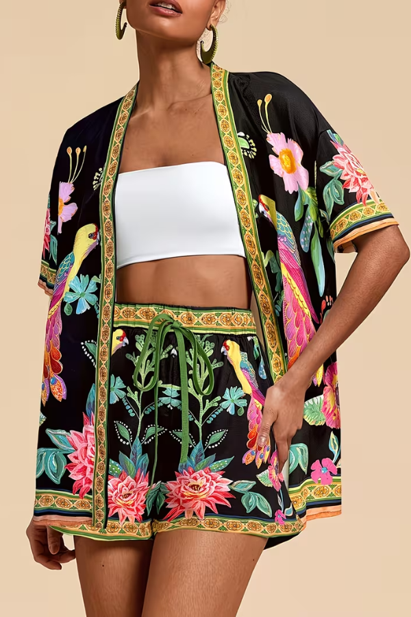 Vibrant floral tropical print women's two-piece summer outfit. Short sleeve top & shorts for a chic, casual beach look.