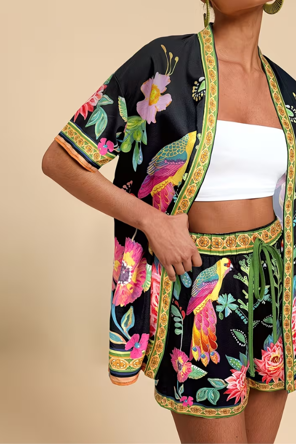 Women's two-piece tropical print set featuring a short sleeve top & matching shorts. Perfect for summer beach fashion.