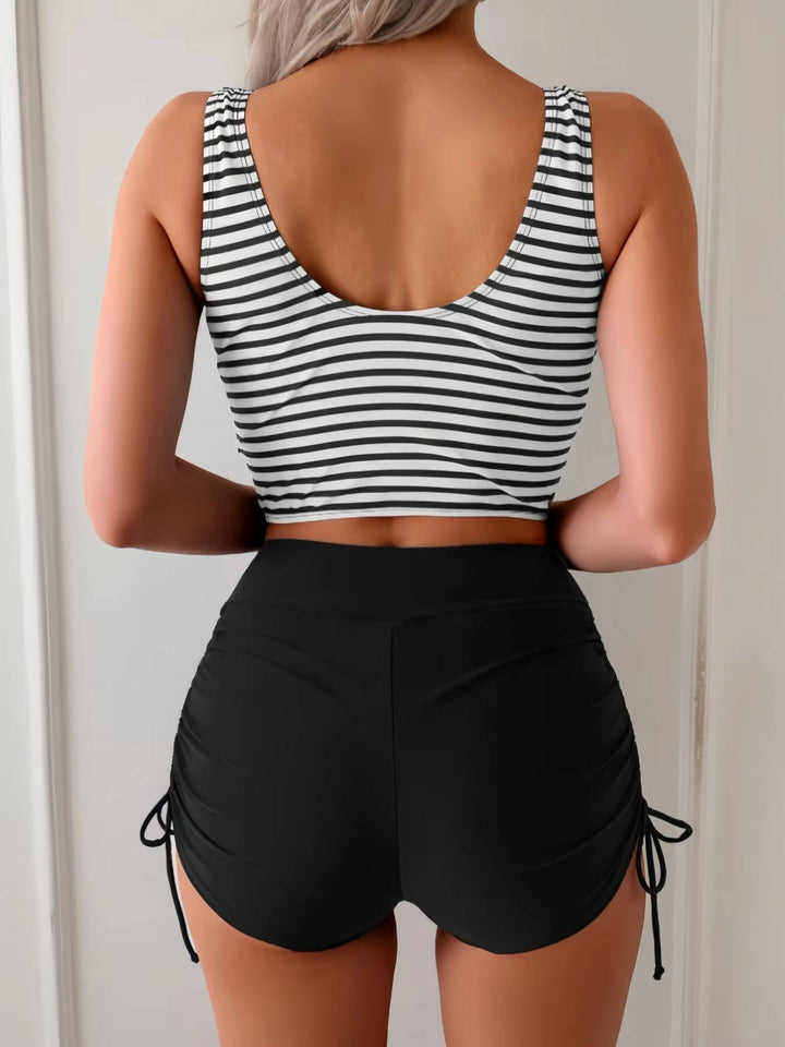 Comfortable women's high-waisted tankini swimsuit. Chic twist front top, great tummy control for beachwear.