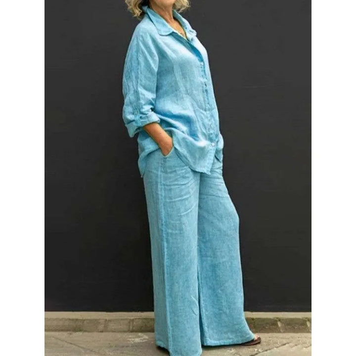 Comfortable women's loungewear two-piece featuring a button-up shirt and relaxed wide-leg trousers.
