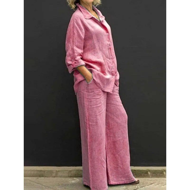 Chic women's matching set with a long-sleeve button-up shirt and flowy wide-leg trousers.