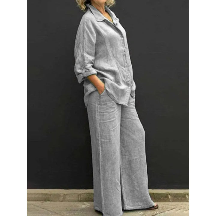 Model showcasing a women's two-piece set: button-up shirt and wide-leg trousers, a stylish spring outfit.