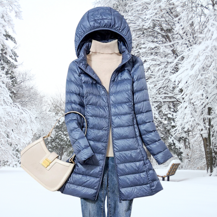 Close-up of the ultra-light insulated fabric on a women's hooded jacket, offering warmth without bulk.