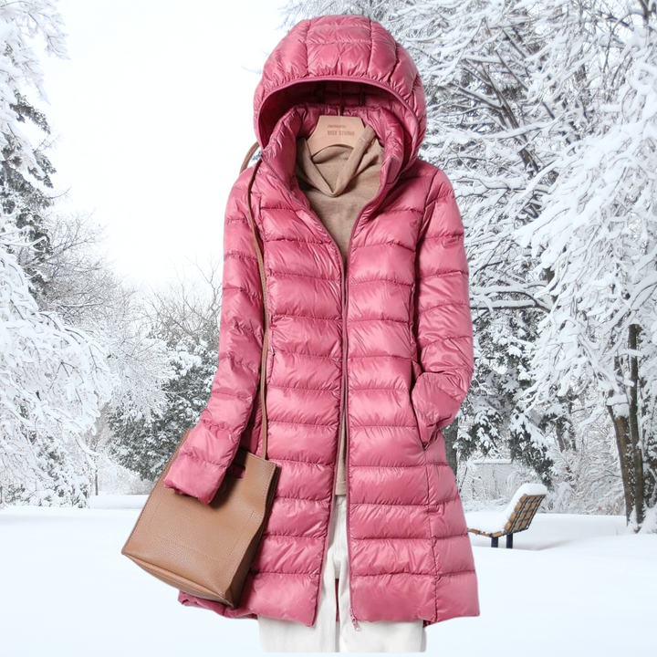 Woman hiking in an ultra-light insulated hooded jacket, perfect outerwear for active travel & cool weather.