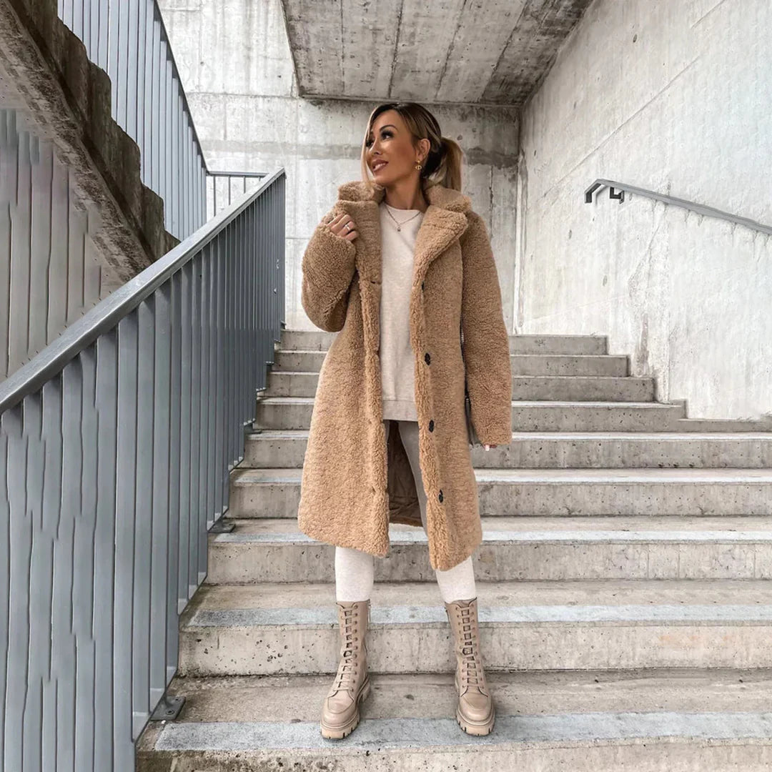 Stylish women's oversized long teddy coat with a wide lapel, offering warmth & comfort for winter fashion outerwear.