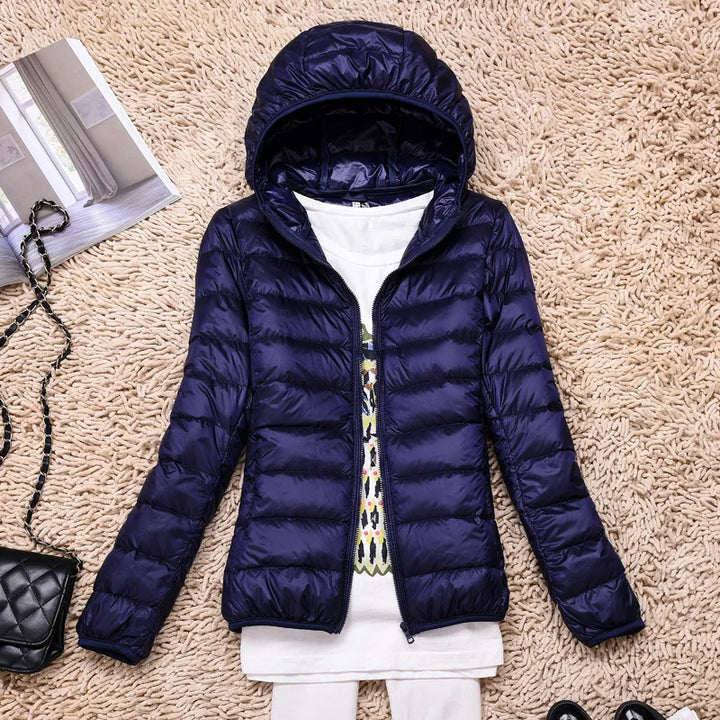 Women's versatile lightweight coat, ideal for layering, insulated & hooded for protection.