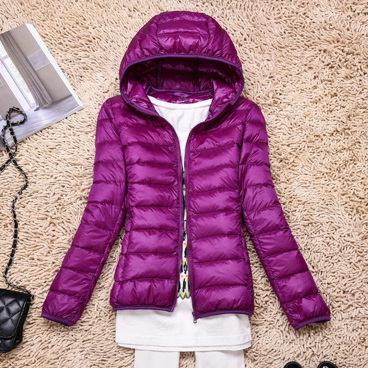 Women's active lifestyle jacket, ultralight, insulated, hooded for weather protection.