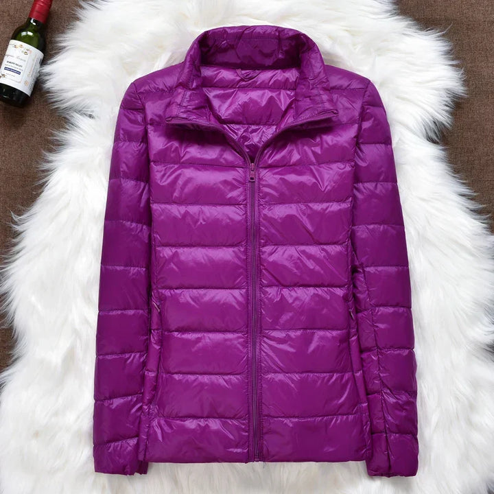Stylish and warm women's hooded jacket, packable for on-the-go comfort and ease.