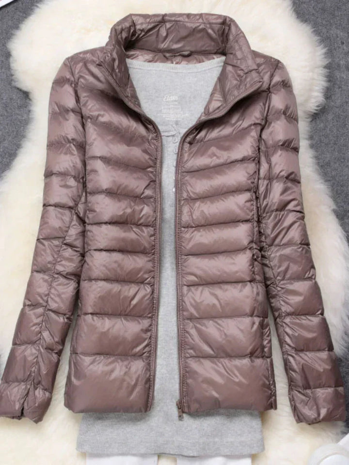 Lightweight women's winter jacket, packable design, excellent for travel and cold weather.