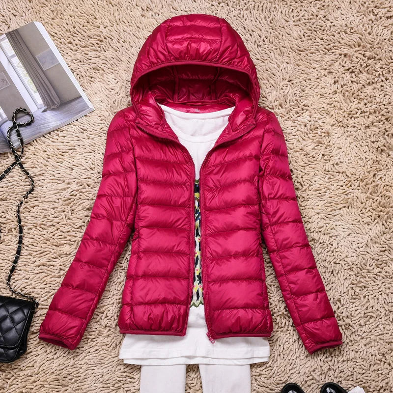 Warm women's travel jacket, packable and hooded, essential outerwear for cool weather.