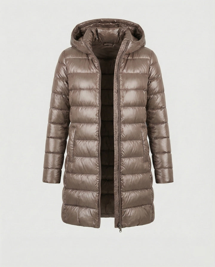 Transitional women's jacket: ultralight, insulated, and hooded, suitable for changing weather.