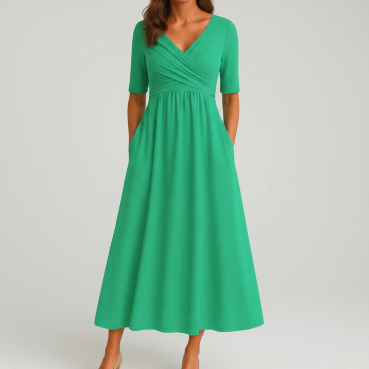 Versatile women's midi dress with a V-neck, A-line cut, and convenient pockets, suitable for any occasion.