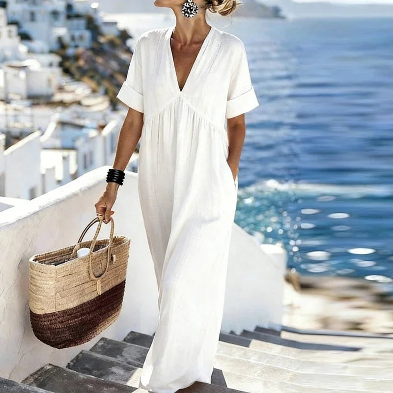 Elegant women's short-sleeve V-neck bohemian maxi dress with practical pockets, a chic flowy summer style.