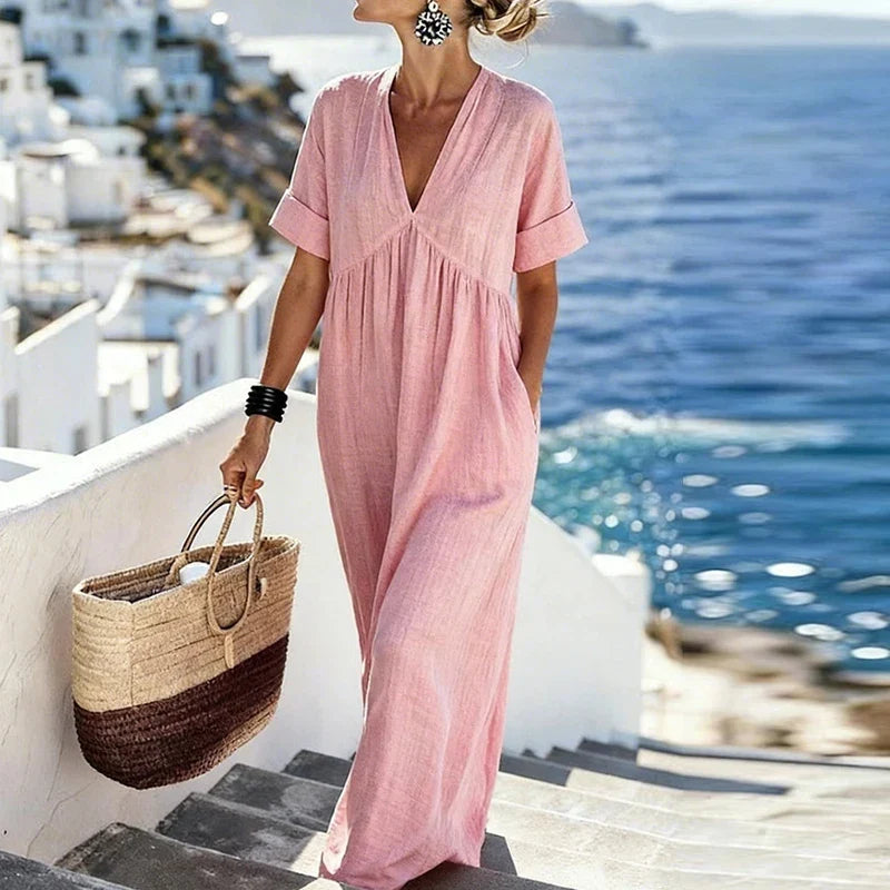Bohemian V-neck maxi dress for women, featuring short sleeves and pockets. A comfortable, flowy summer vacation outfit.