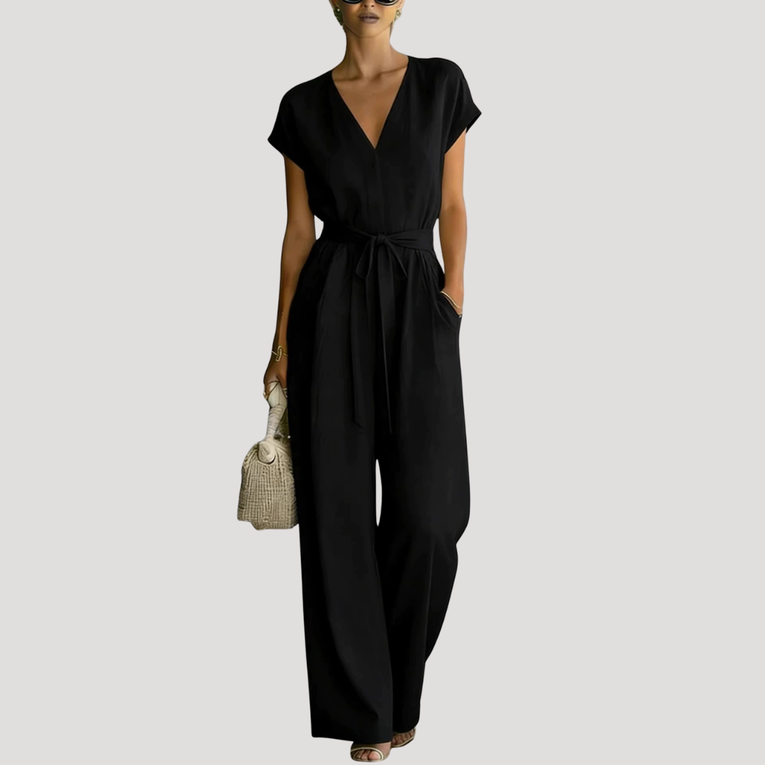 Elegant women's V-neck cap sleeve wide leg jumpsuit with a chic tie waist detail, ideal for summer events.