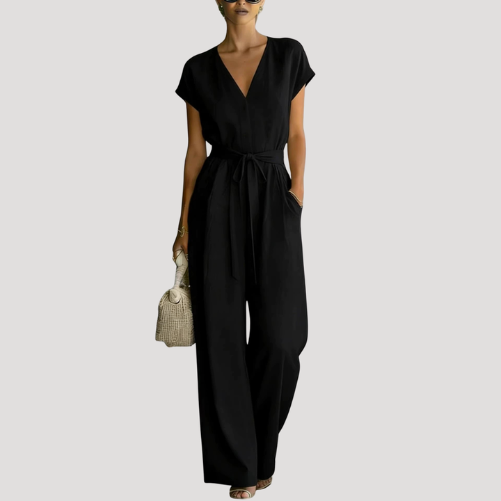 Elegant women's V-neck cap sleeve wide leg jumpsuit with a chic tie waist detail, ideal for summer events.
